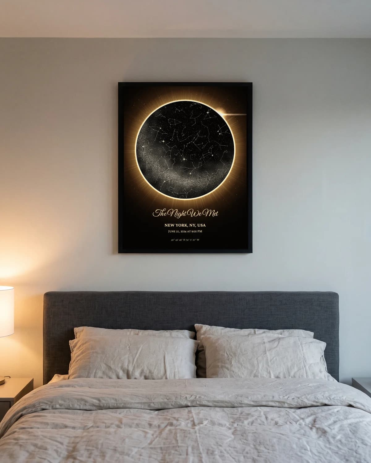 The Eclipse star map in a black frame above a bed: the night sky inside a golden solar corona